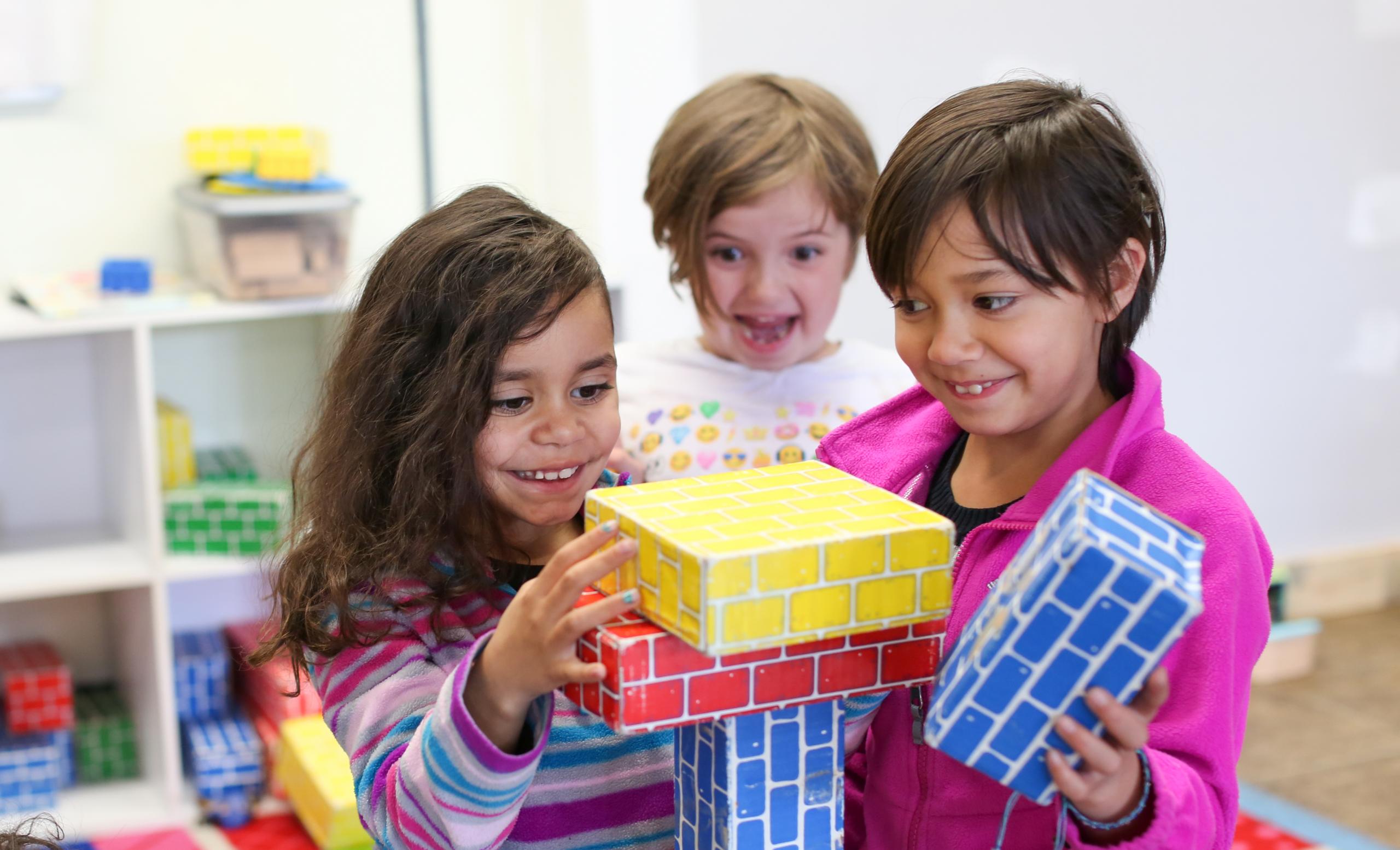 youth create a block tower