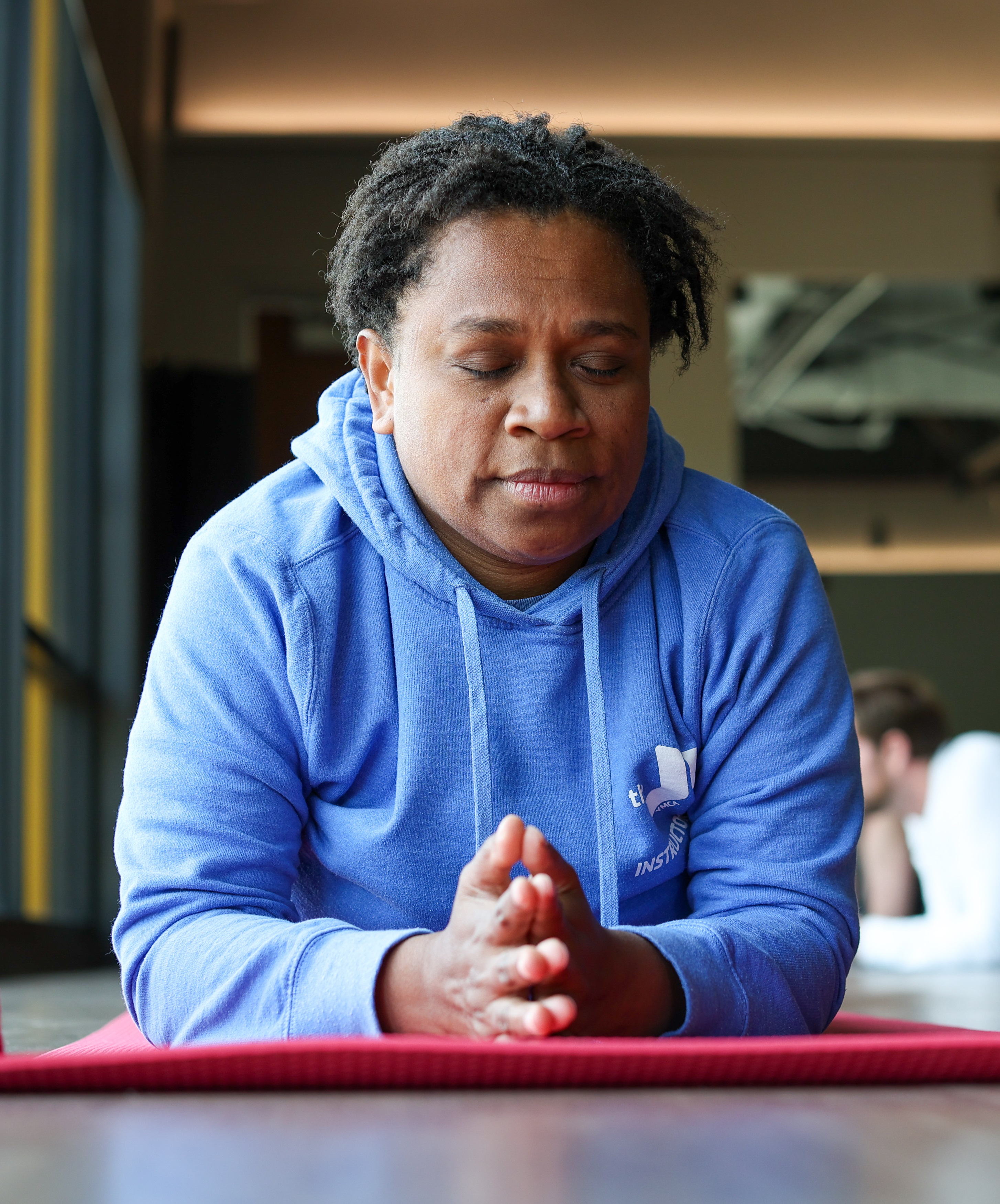 Y member meditates in yoga pose at the Y