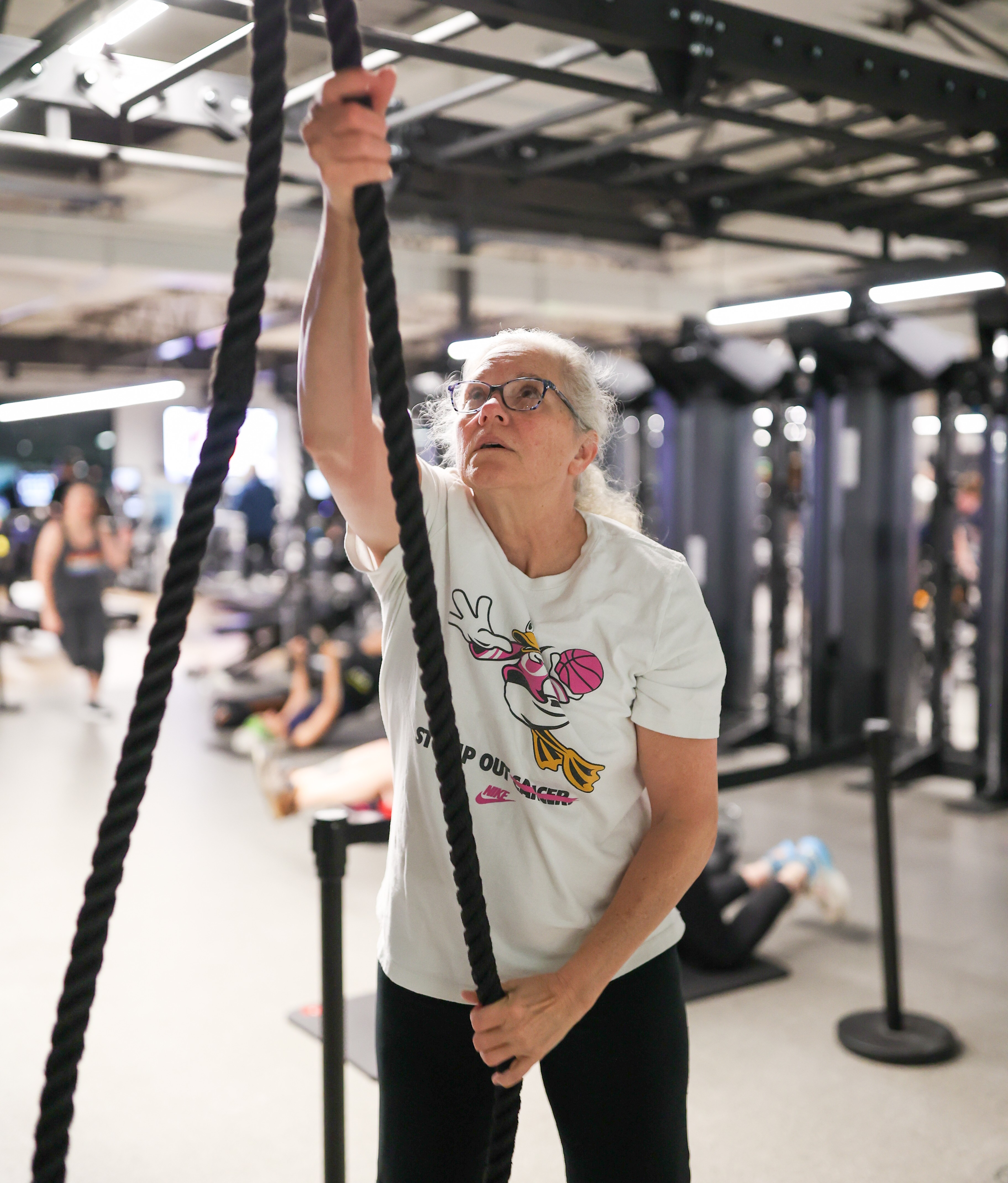 Y member exercises with endless rope machine