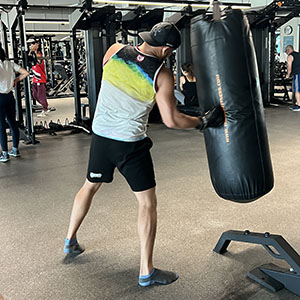 man punching heavy bag