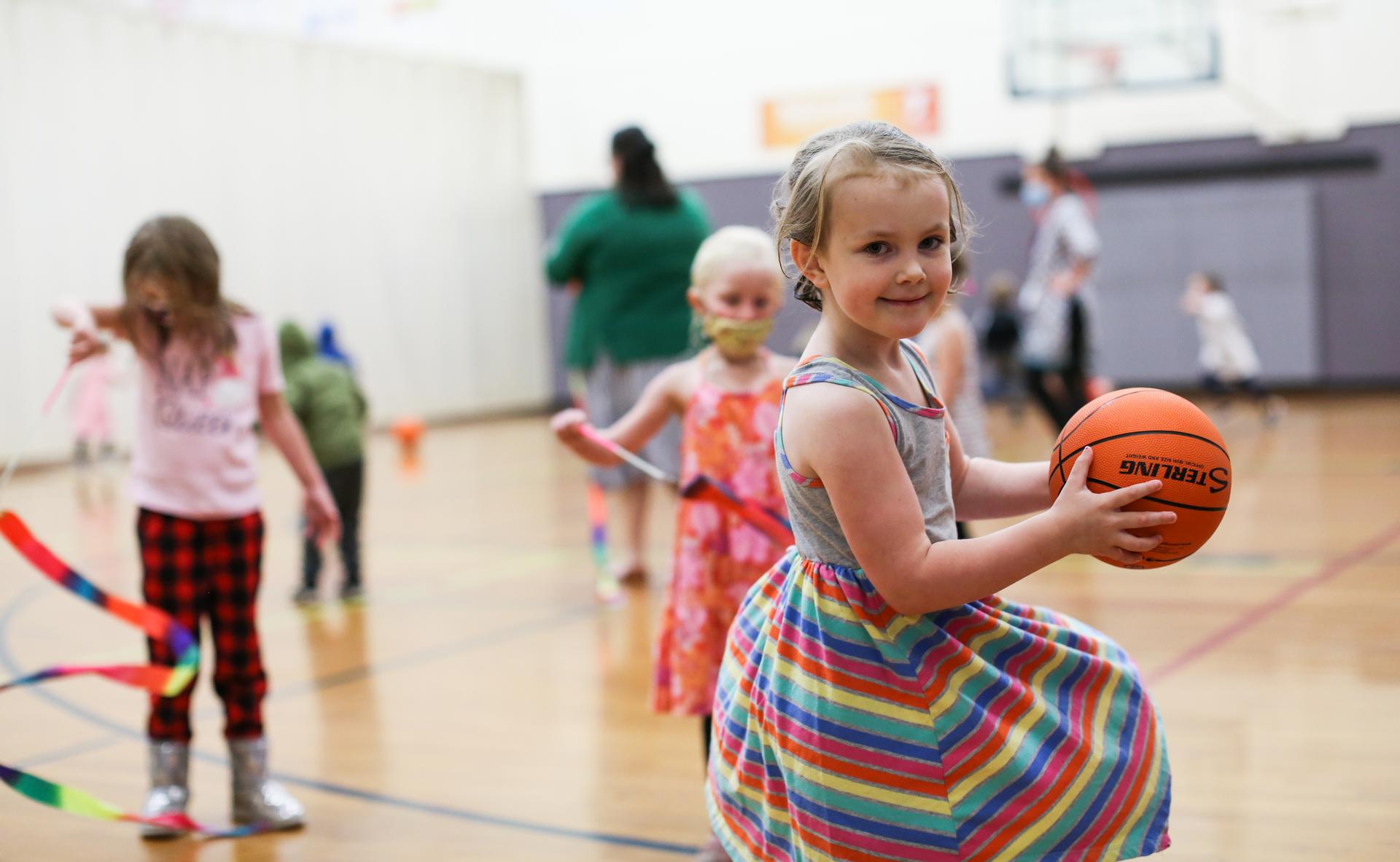 a youth learns basketball in the ymca gym