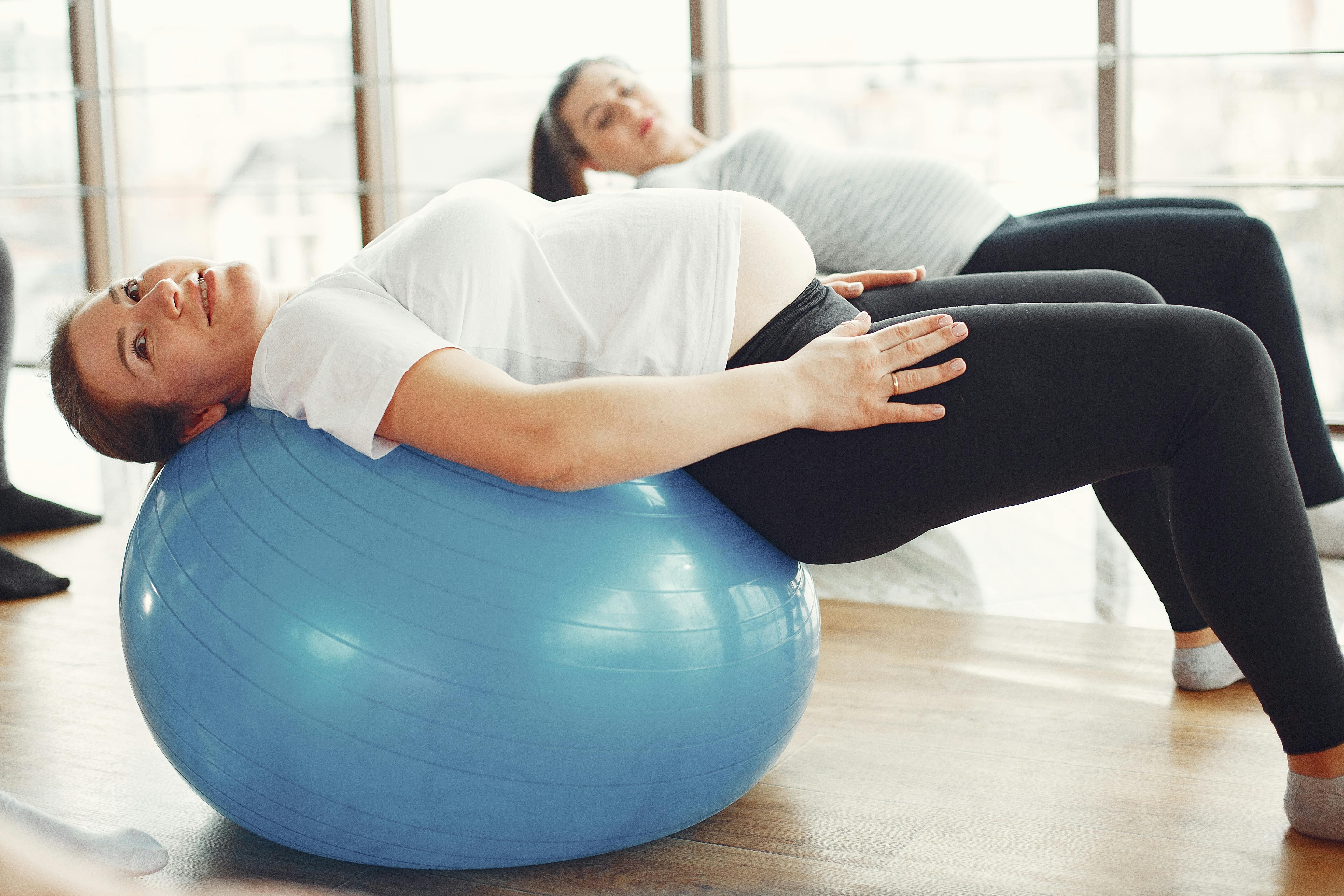 pregnant women practicing yoga