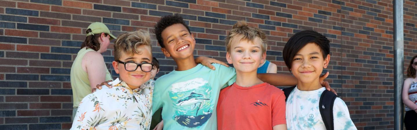Kids hug and pose for the camera at eugene ymca summer camp