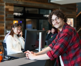 young man askes membership questions at ymca front desk