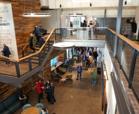 community members talk and walk around the eugene ymca lobby