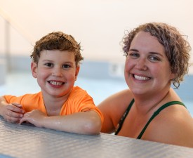 Happy mom and child at swim lessons